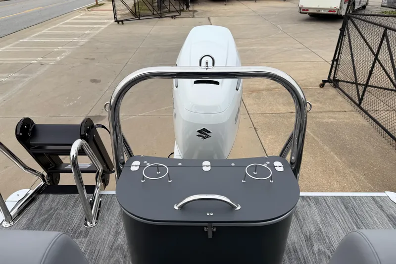 Slide: The Image of 2026 Avalon Catalina Quad Lounger Windshield boat with Suzuki outboard motor, docked on pavement. - 29