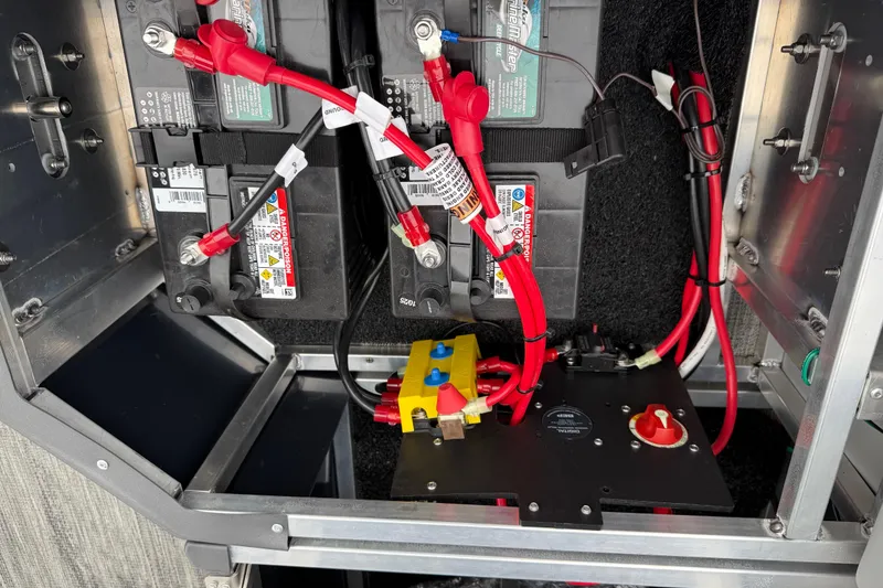 Slide: The Image of Battery compartment of 2026 Avalon Catalina Quad Lounger Windshield with wiring and connections. - 38