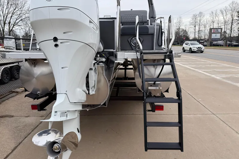 Slide: The Image of 2026 Avalon Catalina Quad Lounger Windshield boat with outboard motor and boarding ladder. - 43