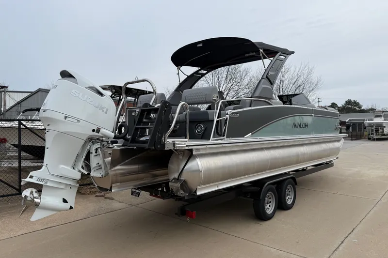 Slide: The Image of 2026 Avalon Catalina Quad Lounger Windshield boat with Suzuki outboard motor on trailer. - 6