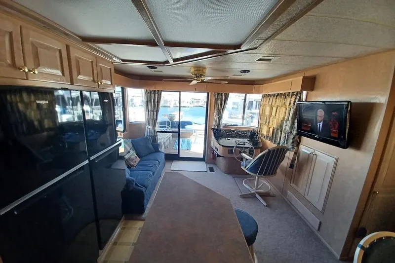 Slide: The Image of Interior of a 1996 Stardust Cruisers 1655 houseboat with cozy seating and modern amenities. - 10