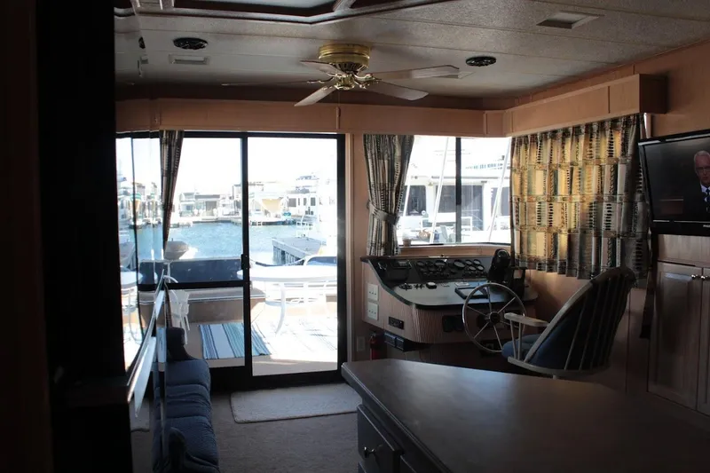 Slide: The Image of Interior of 1996 Stardust Cruisers 1655 houseboat with helm, seating, and waterfront view. - 11