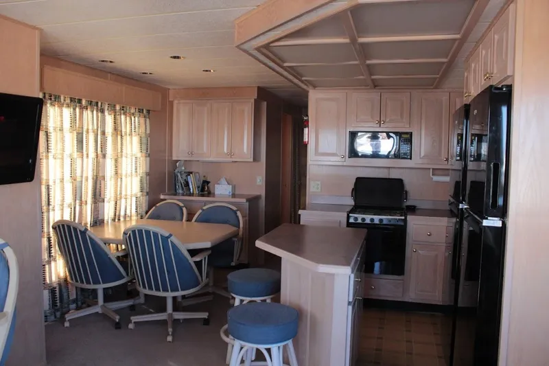 Slide: The Image of Interior of a 1996 Stardust Cruisers 1655 houseboat with kitchen and dining area. - 13