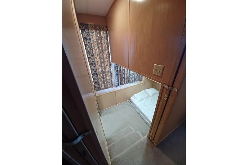 Slide: The Image of 1996 Stardust Cruisers 1655 interior with cozy bed and patterned curtains. - 19
