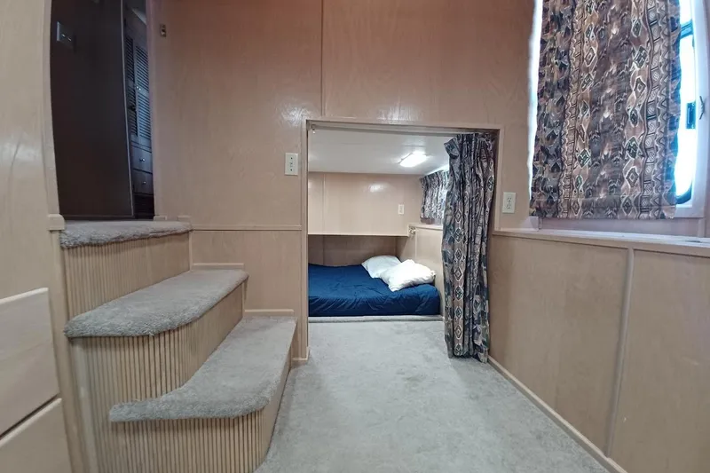 Slide: The Image of Interior of 1996 Stardust Cruisers 1655 with cozy bedroom and carpeted stairs. - 21