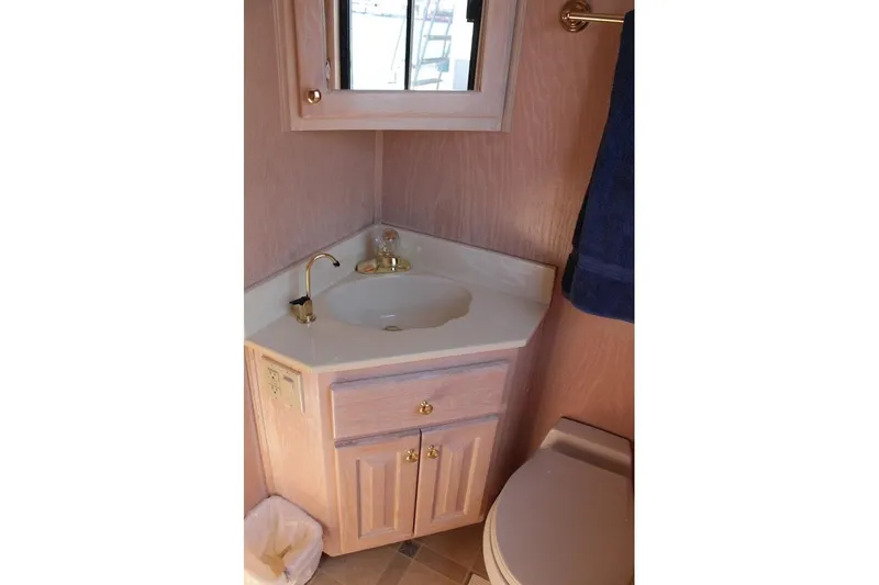 Slide: The Image of Bathroom vanity in 1996 Stardust Cruisers 1655, featuring a sink and wooden cabinetry. - 30