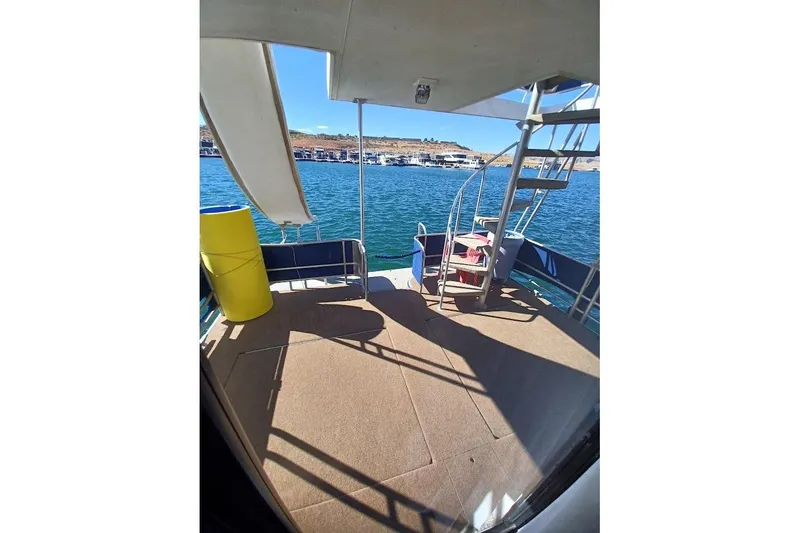 Slide: The Image of 1996 Stardust Cruisers 1655 boat deck with spiral staircase and lake view. - 32