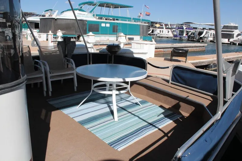Slide: The Image of Outdoor seating area on a 1996 Stardust Cruisers 1655 houseboat at a marina. - 36