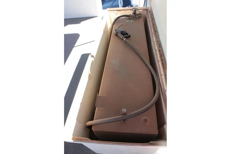 Slide: The Image of Fuel tank of a 1996 Stardust Cruisers 1655 houseboat, with attached hose. - 38