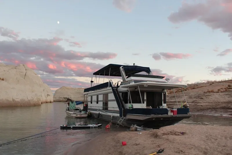 Slide: The Image of Houseboat docked on sandy shore at sunset, 1996 Stardust Cruisers 1655. - 4