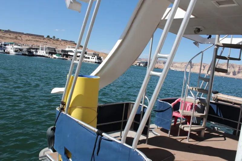 Slide: The Image of Houseboat with slide and spiral staircase on a lake, Stardust Cruisers 1655, 1996 model. - 43
