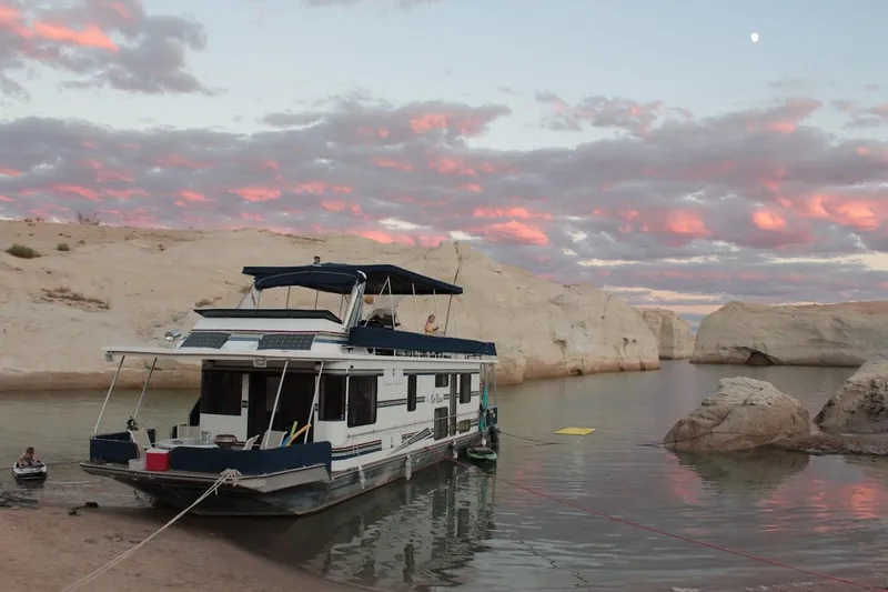 Slide: The Image of 1996 Stardust Cruisers 1655 houseboat moored on serene lake at sunset with pink clouds. - 5