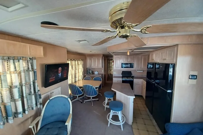 Slide: The Image of Interior of a 1996 Stardust Cruisers 1655 houseboat with kitchen and seating area. - 8