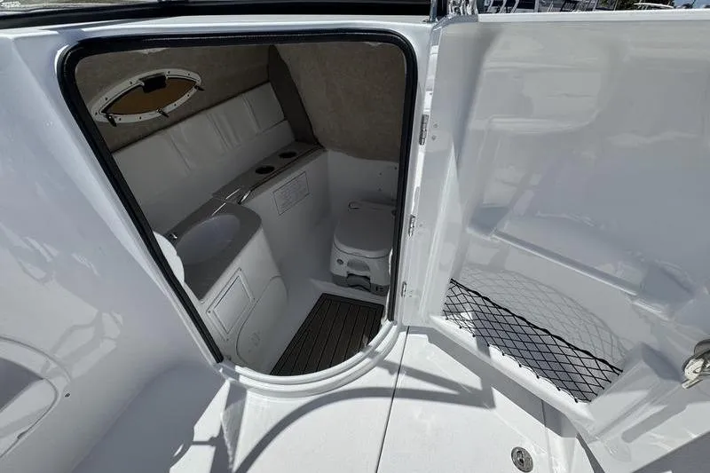 Slide: The Image of 2025 Stingray 231DC boat interior with compact bathroom and modern amenities. - 11