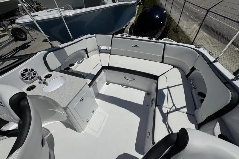 Slide: The Image of 2025 Stingray 231DC boat interior with spacious seating and modern amenities. - 14