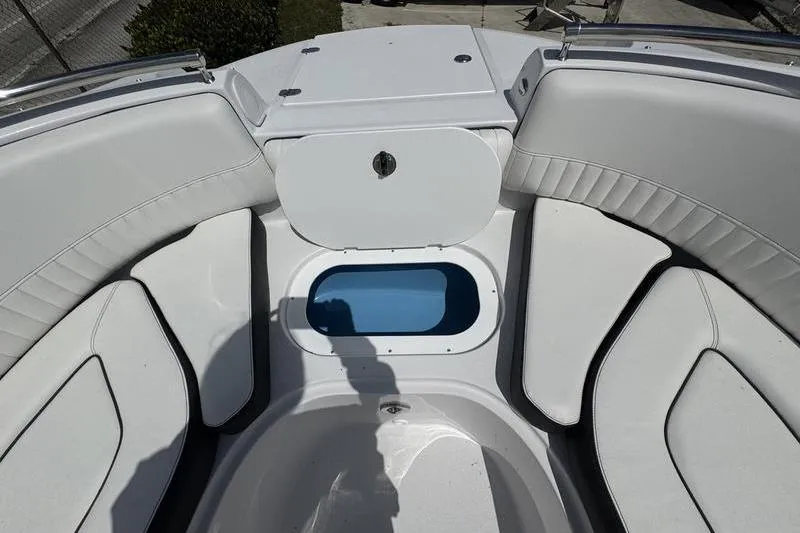 Slide: The Image of 2025 Stingray 231DC boat interior with white seating and storage compartment. - 7