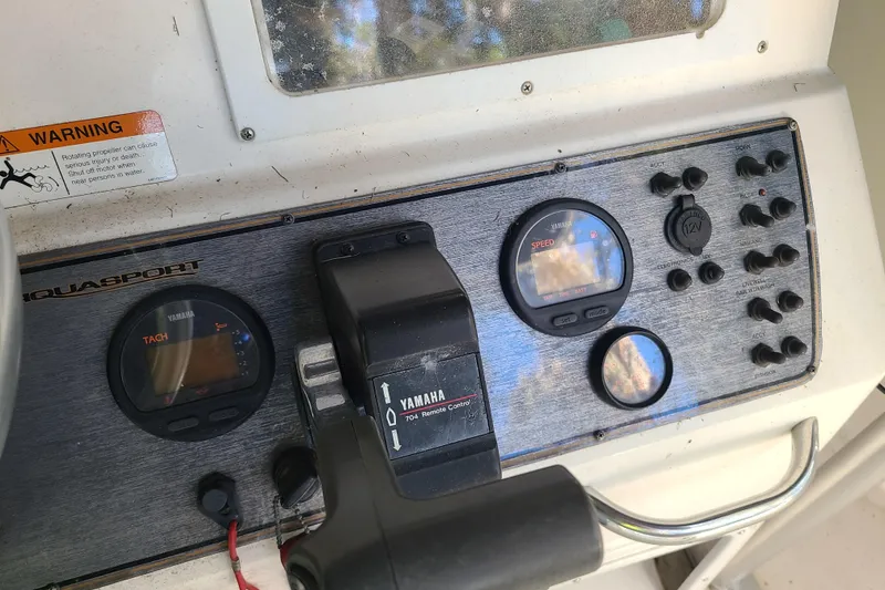 Slide: The Image of Control panel of a 2003 Aquasport 205 Osprey boat with Yamaha gauges and controls. - 11