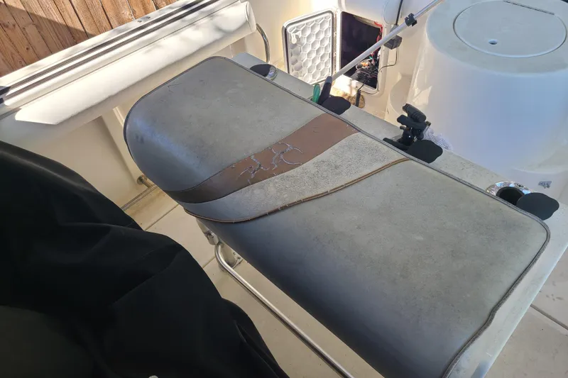 Slide: The Image of Worn seat on 2003 Aquasport 205 Osprey boat, showing signs of aging and use. - 13