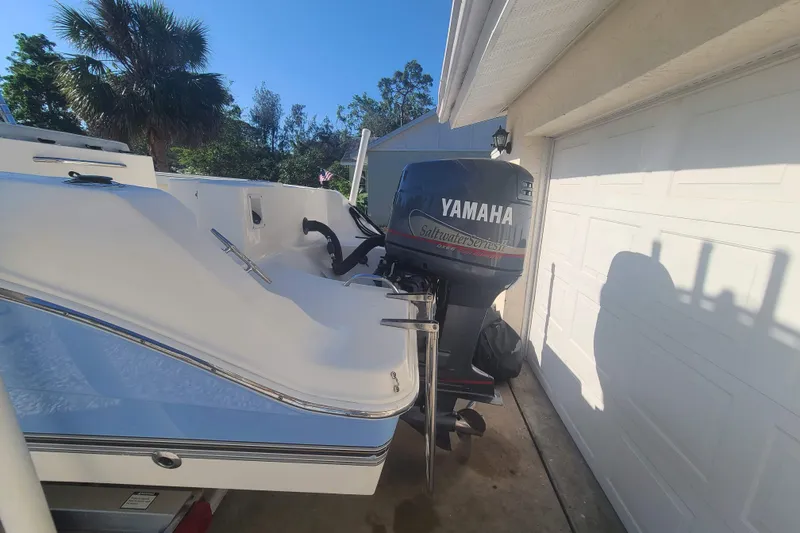 Slide: The Image of 2003 Aquasport 205 Osprey boat with Yamaha outboard motor in driveway. - 16
