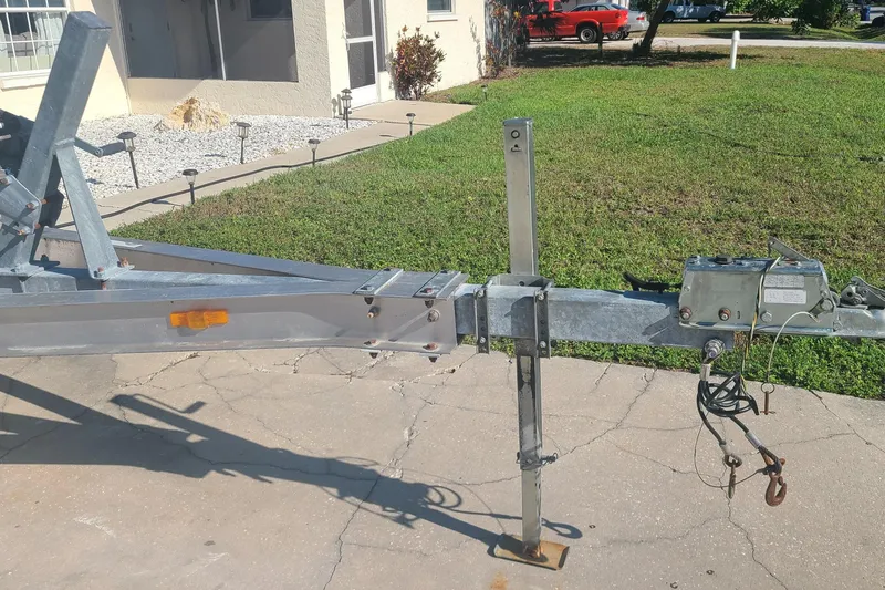 Slide: The Image of Trailer hitch for 2003 Aquasport 205 Osprey boat on concrete driveway. - 23