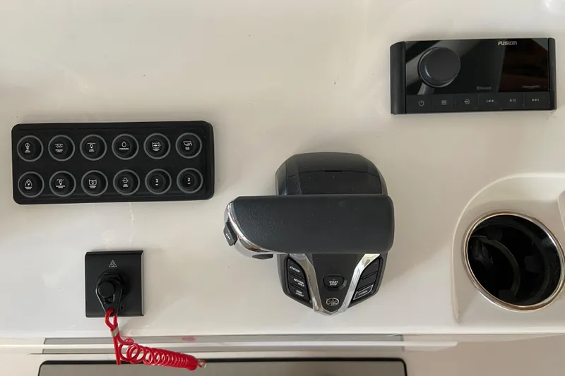 Slide: The Image of 2026 Sportsman Open 232 Center Console dashboard with controls and cup holder. - 14