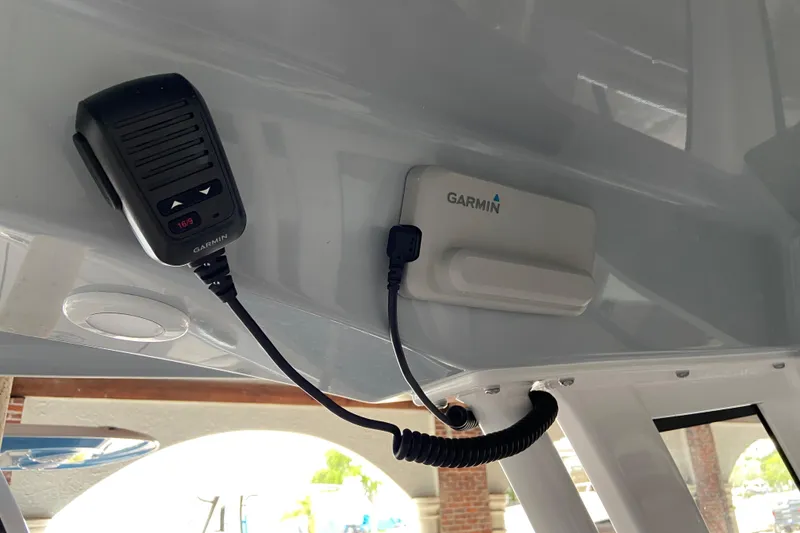 Slide: The Image of Garmin marine radio and antenna on 2026 Sportsman Open 232 Center Console boat. - 17