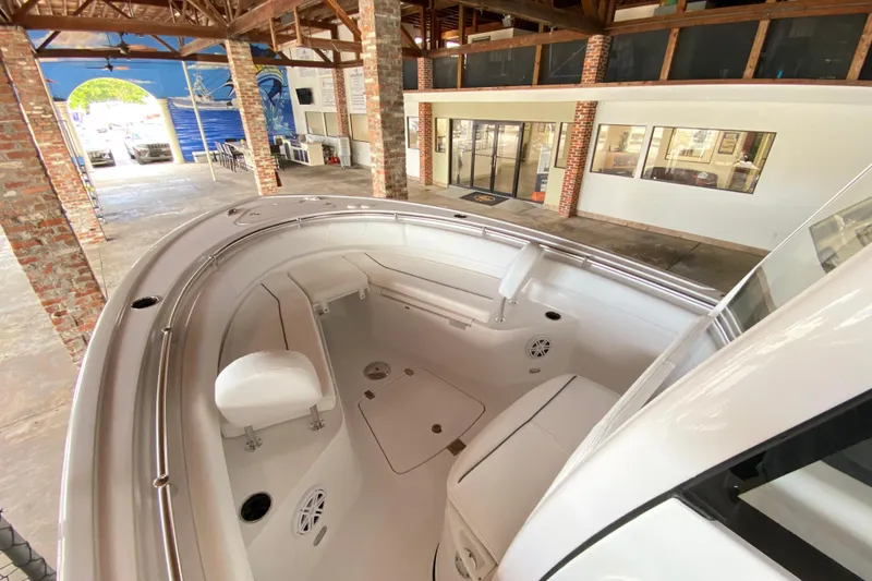 Slide: The Image of 2026 Sportsman Open 232 Center Console boat interior in a showroom setting. - 18