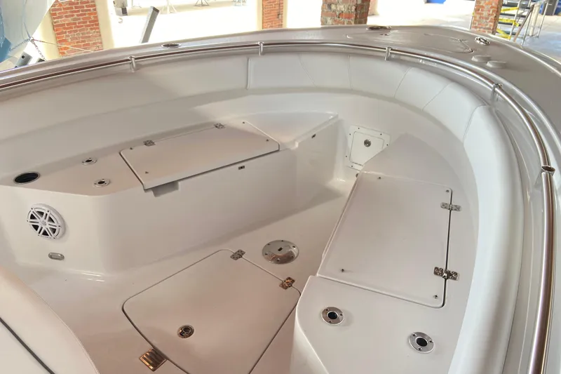 Slide: The Image of 2026 Sportsman Open 232 Center Console boat interior with storage compartments and seating. - 19