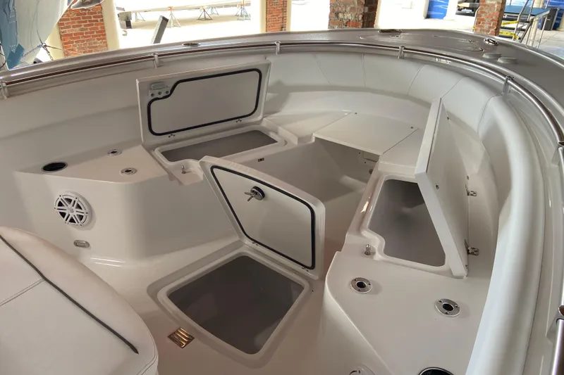 Slide: The Image of 2026 Sportsman Open 232 Center Console boat interior with storage compartments open. - 20