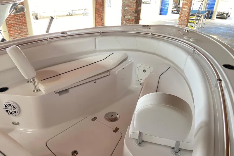 Slide: The Image of 2026 Sportsman Open 232 Center Console boat interior with white seating and stainless steel railings. - 22
