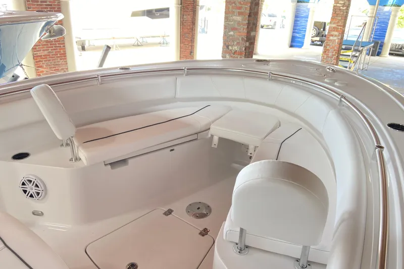 Slide: The Image of 2026 Sportsman Open 232 Center Console boat interior with white seating and table. - 23