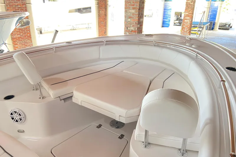 Slide: The Image of 2026 Sportsman Open 232 Center Console boat interior with cushioned seating and sleek design. - 24