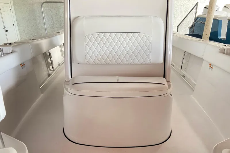 Slide: The Image of 2026 Sportsman Open 232 Center Console boat interior with white cushioned seating. - 28