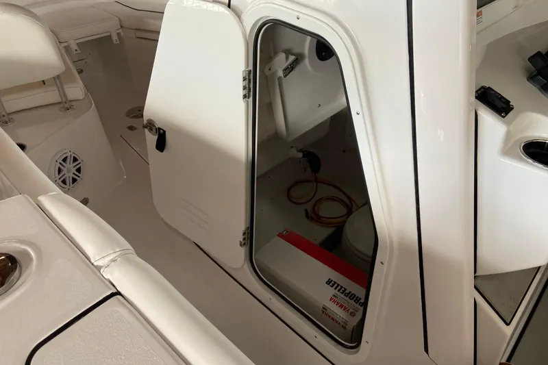 Slide: The Image of 2026 Sportsman Open 232 Center Console interior with open storage compartment. - 31