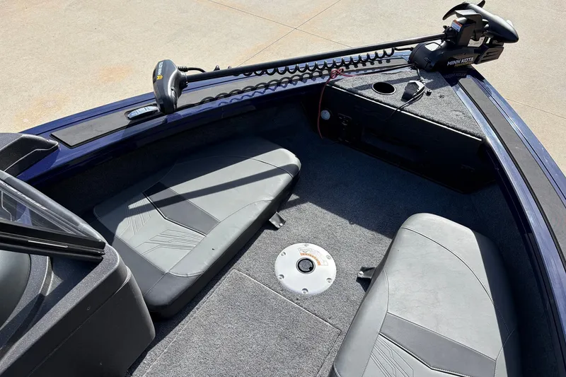 Slide: The Image of 2024 Tracker Targa V-18 Combo boat interior with seating and Minn Kota trolling motor. - 13