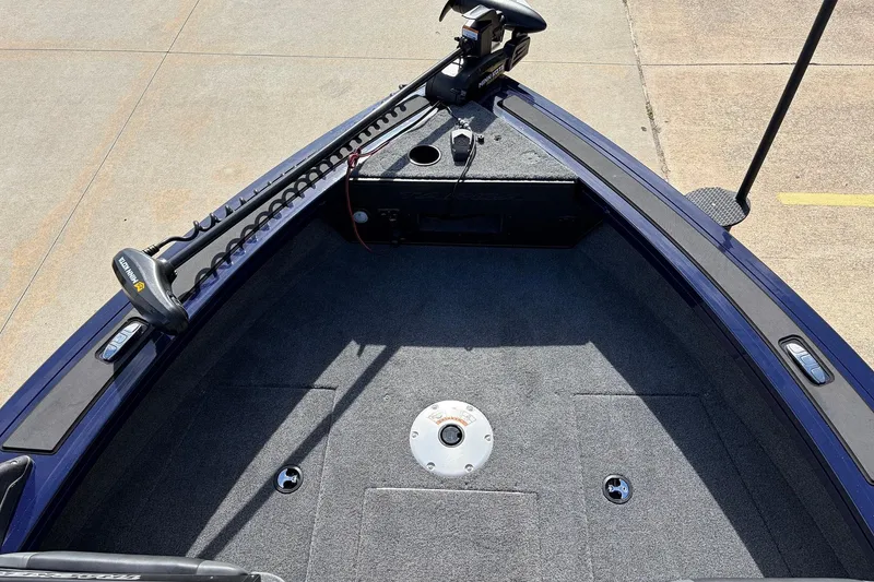 Slide: The Image of 2024 Tracker Targa V-18 Combo boat deck with trolling motor, carpeted surface. - 17