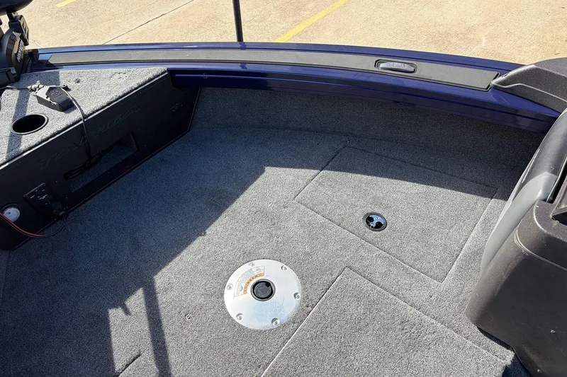 Slide: The Image of 2024 Tracker Targa V-18 Combo boat interior with carpeted deck and storage compartments. - 19