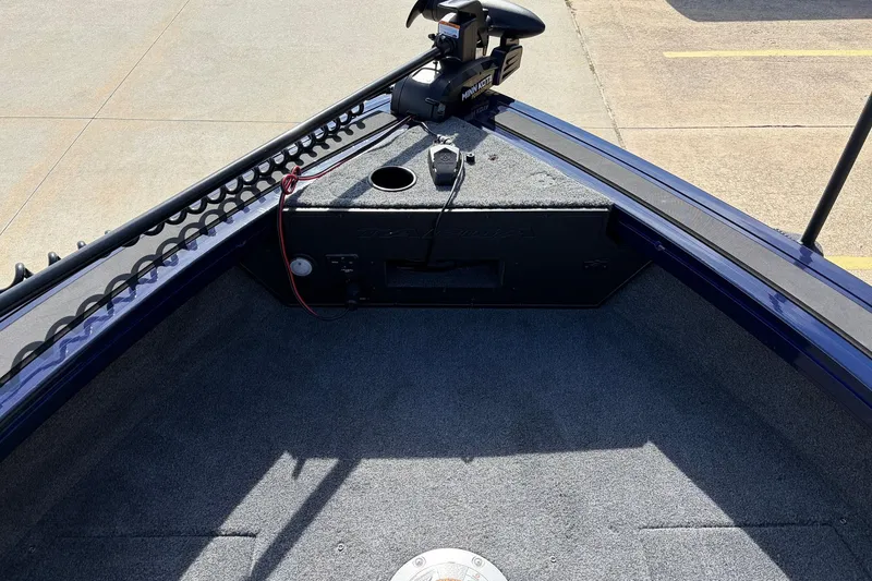 Slide: The Image of 2024 Tracker Targa V-18 Combo boat interior with trolling motor and carpeted deck. - 20