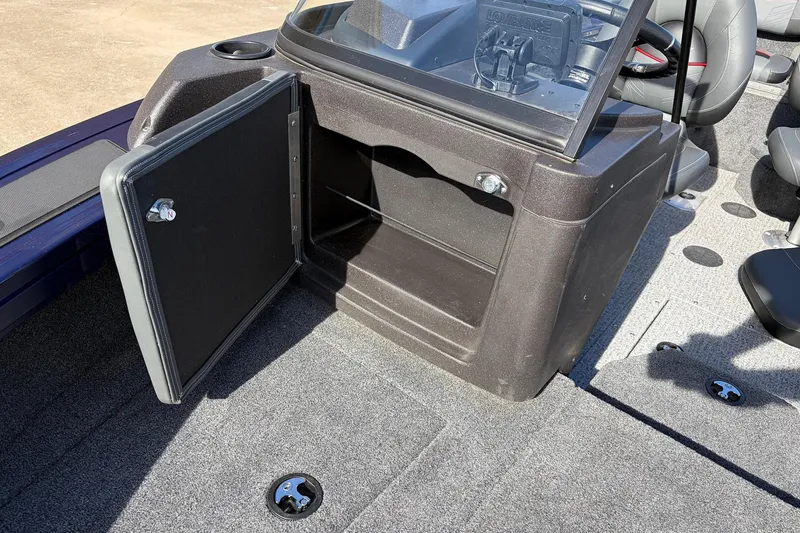Slide: The Image of 2024 Tracker Targa V-18 Combo boat interior with open storage compartment and seating. - 25