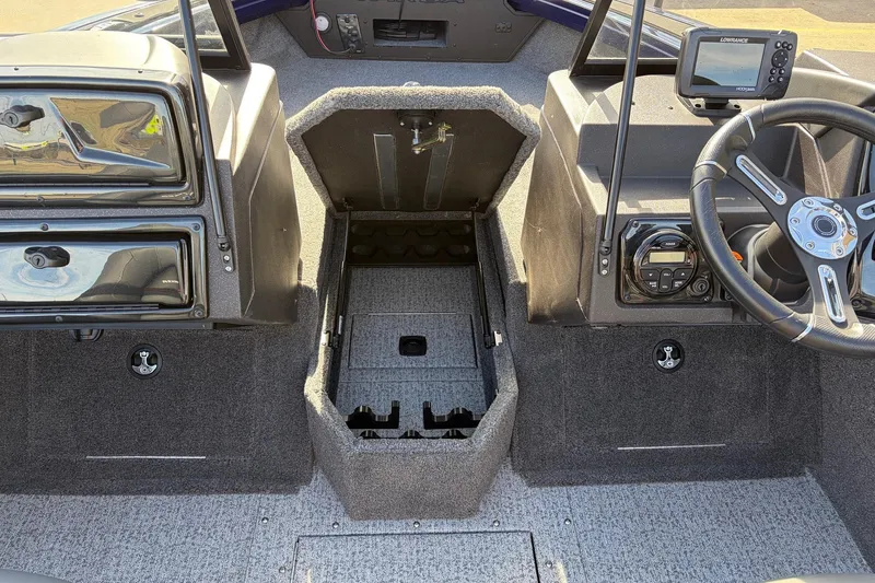 Slide: The Image of 2024 Tracker Targa V-18 Combo boat interior with steering wheel and dashboard controls. - 28