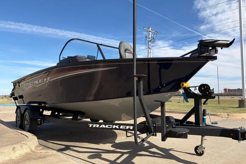 Slide: The Image of 2024 Tracker Targa V-18 Combo boat on trailer, parked outdoors under blue sky. - 3