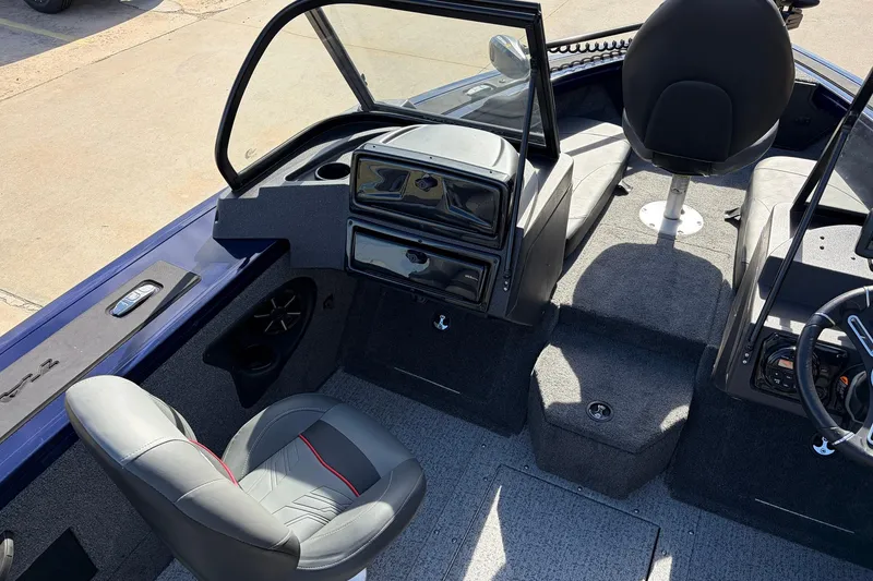 Slide: The Image of 2024 Tracker Targa V-18 Combo boat interior with seating and dashboard view. - 30