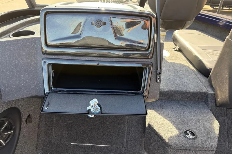 Slide: The Image of 2024 Tracker Targa V-18 Combo boat interior with open storage compartment and seating. - 32