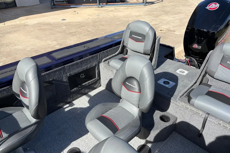 Slide: The Image of 2024 Tracker Targa V-18 Combo boat interior with gray seating and Mercury engine. - 37