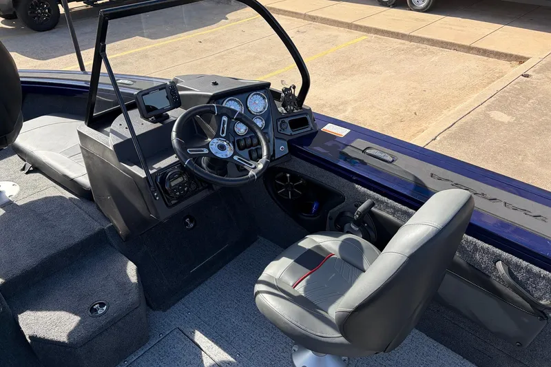 Slide: The Image of 2024 Tracker Targa V-18 Combo boat interior with steering wheel and dashboard controls. - 38