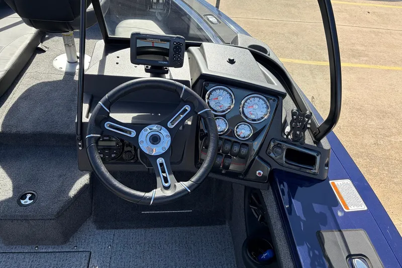 Slide: The Image of 2024 Tracker Targa V-18 Combo boat dashboard with steering wheel and gauges. - 39