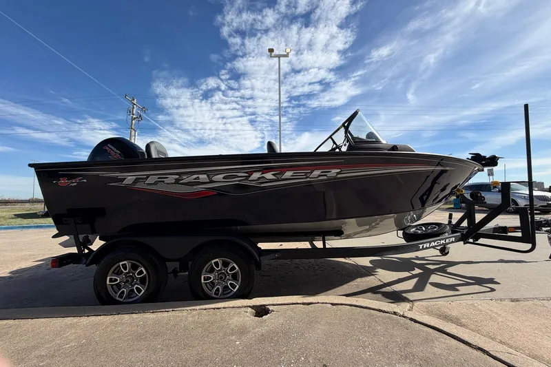 Slide: The Image of 2024 Tracker Targa V-18 Combo boat on trailer under blue sky. - 4