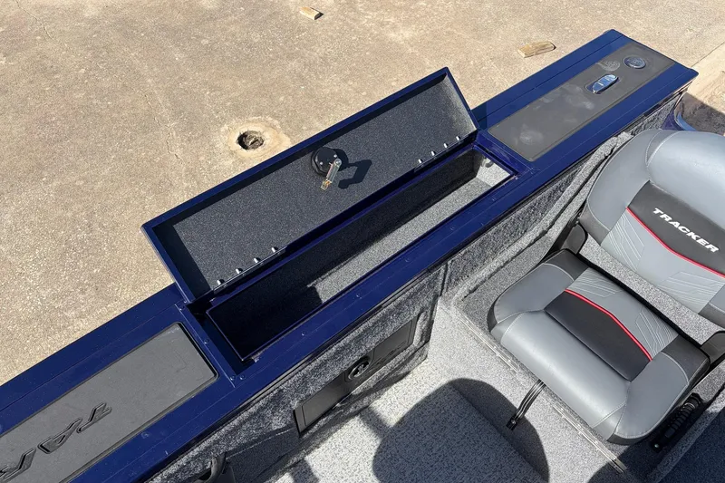 Slide: The Image of 2024 Tracker Targa V-18 Combo boat interior with storage compartment and seat. - 46