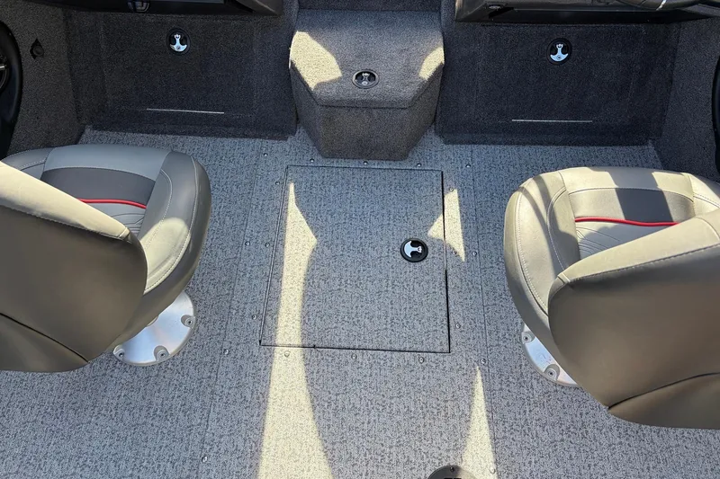 Slide: The Image of 2024 Tracker Targa V-18 Combo interior with two seats and carpeted flooring. - 47