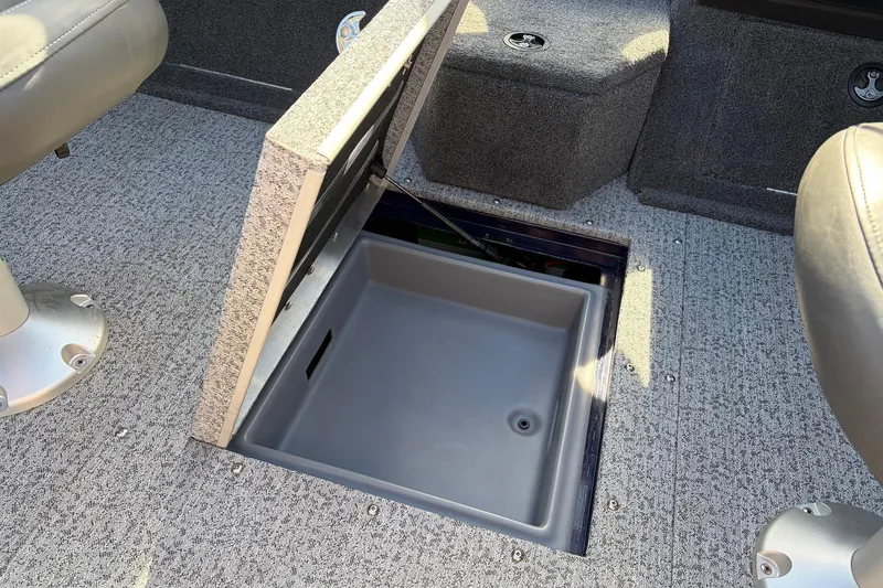 Slide: The Image of 2024 Tracker Targa V-18 Combo boat interior with open storage compartment. - 48